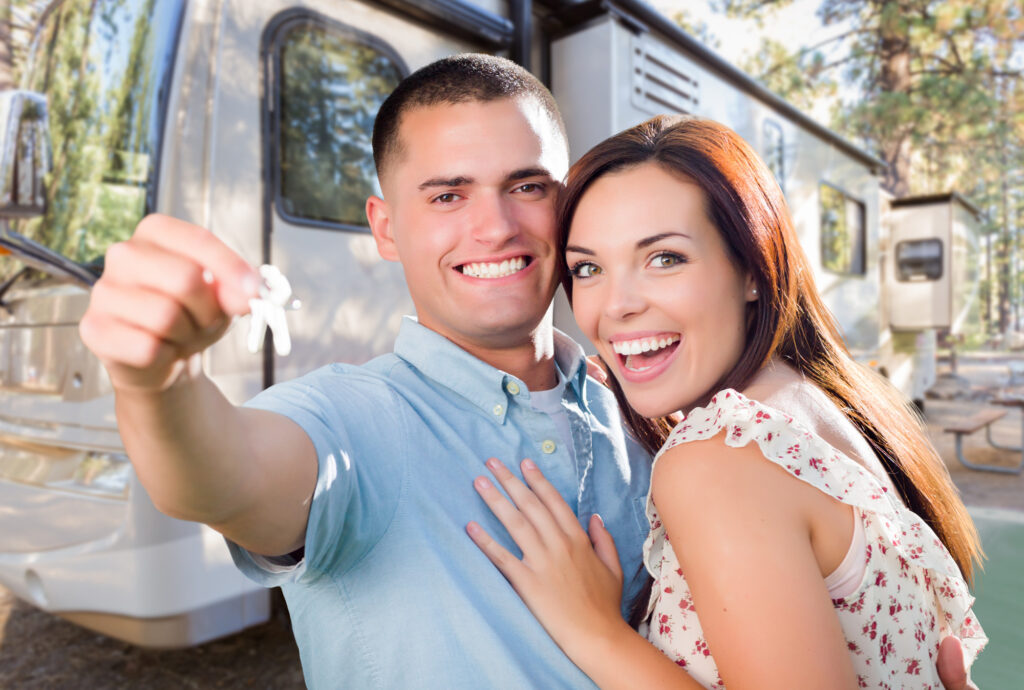 Couple with keys to purchase RV - E